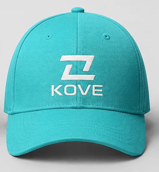 Teal baseball cap with the KOVE logo embroidered in white on the front —the symbol above the wordmark—, a curved brim and ventilation eyelets on the side panels