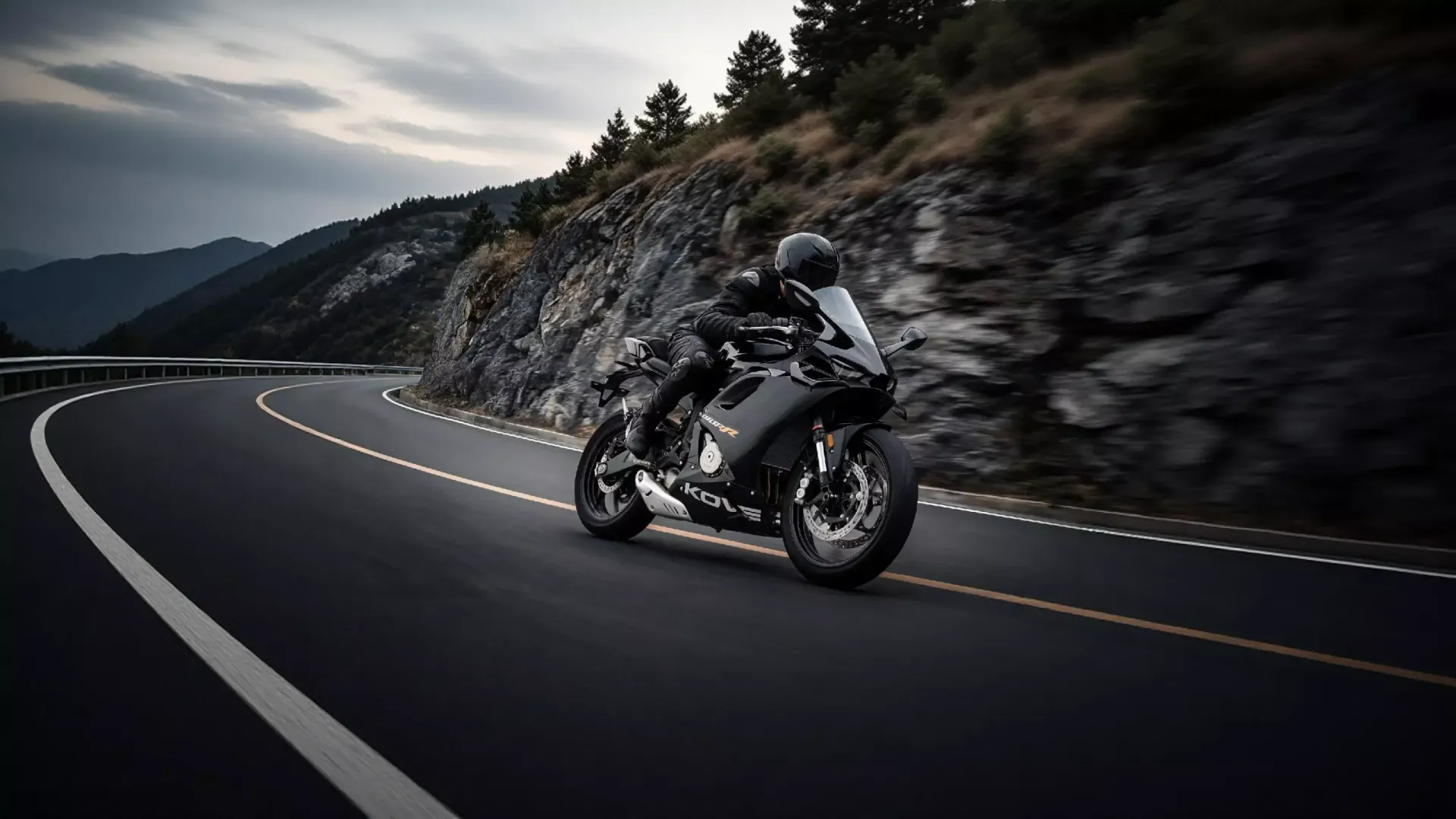 A black KOVE 450 RR leaning into a bend on a mountain road.